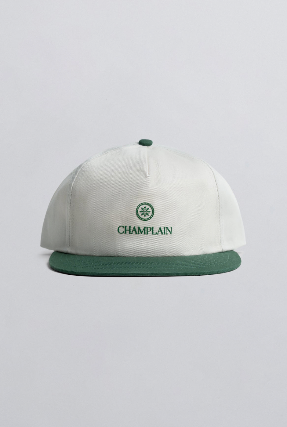 Champlain Cream on Green Hat featuring 5-panel design with contrasting green embroidery and adjustable snapback closure.