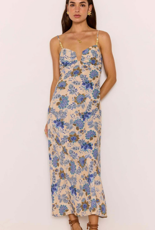 Woman wearing a floral dress on a plain background