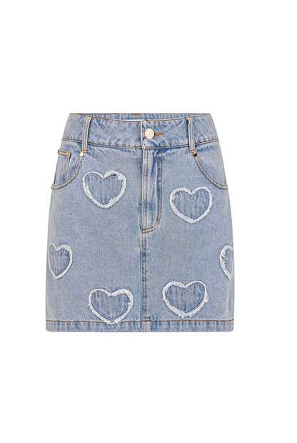 Detail of floral appliqué patches and light wash denim texture