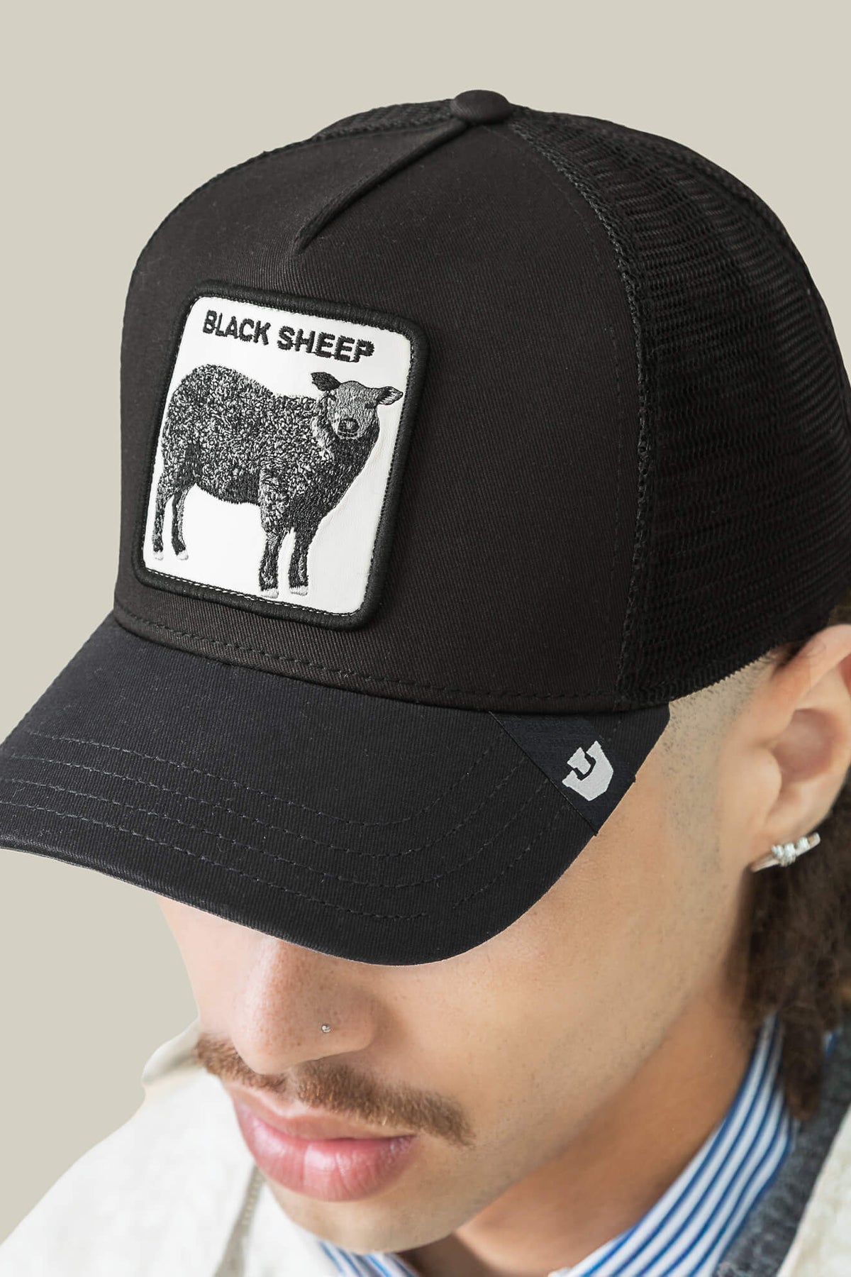Goorin Bros Black Sheep trucker hat in Void worn by model with embroidered sheep patch