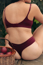Huha Crossover Bra in Merlot burgundy, back hook-and-eye closure on a model