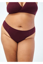 Huha Low Profile Thong underwear in Merlot burgundy, smooth low-mid-rise front on a model