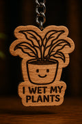 Two Makers Crew I Wet My Plants Keychain — Smiling potted-plant design with I Wet My Plants lettering