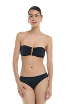 Skye Solids Leslie Bandeau Bikini Top in black on a model, front view
