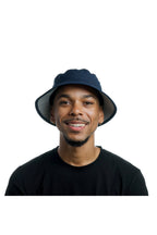 Model wearing the melin Caddy Hydro performance bucket hat in Navy