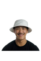 Model wearing the melin Caddy Hydro performance bucket hat in White