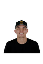 Model wearing the melin Odysea Stacked Hydro performance snapback hat in Black/Gum