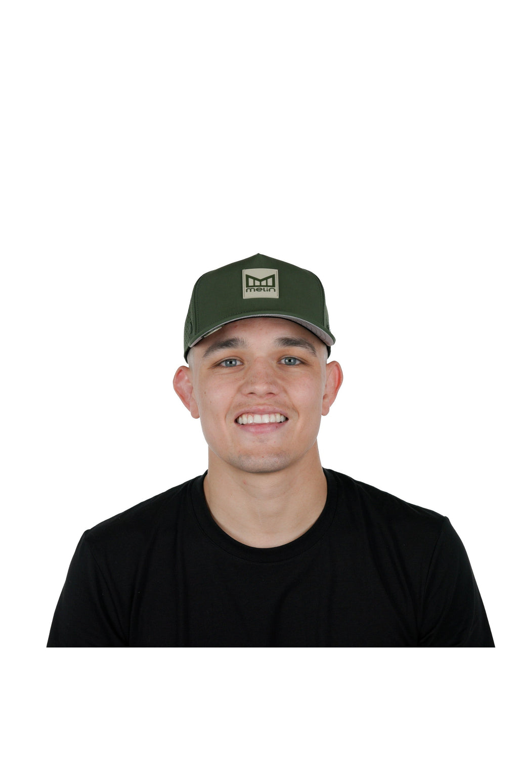 Model wearing the melin Odysea Stacked Hydro performance snapback hat in Canopy/Khaki