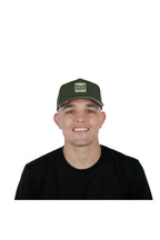 Model wearing the melin Odysea Stacked Hydro performance snapback hat in Canopy/Khaki