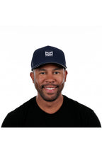 Model wearing the melin Odysea Stacked Hydro performance snapback hat in Navy