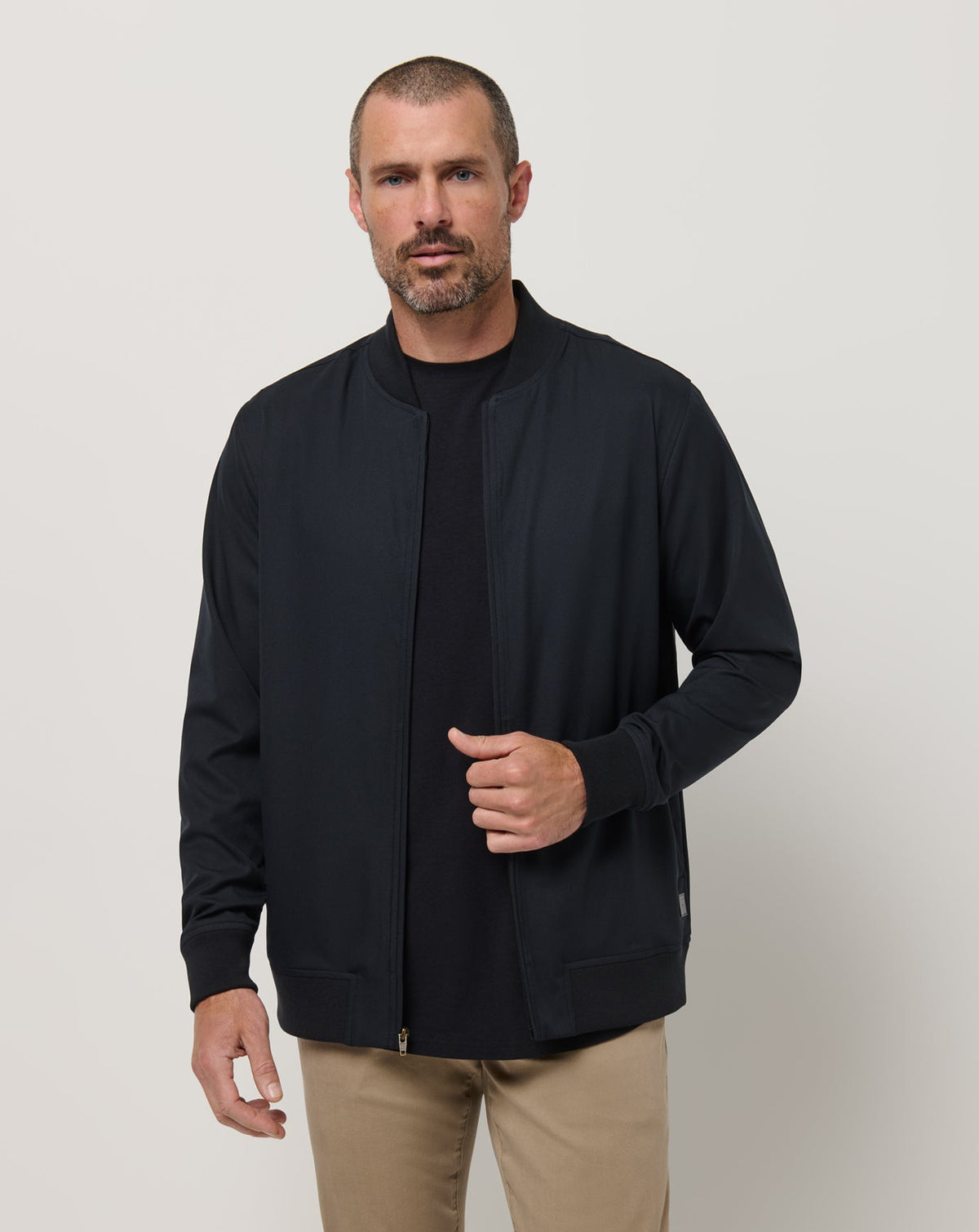 TravisMathew Highway Men Jacket in Black lightweight bomber jacket front view